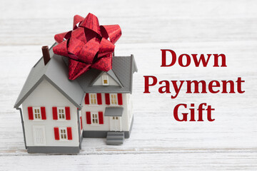 Down Payment Gift with a house with a bow on a desk