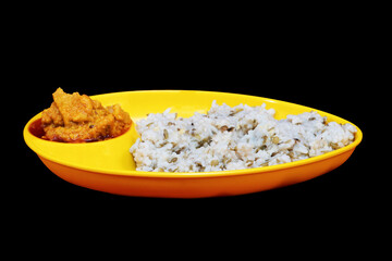 Side view of Gujarati Kathiyawadi Spicy Dhokali Sabji with khichdi, on yellow dish prominently, set against a black background