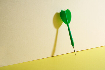 green color dart on yellow background