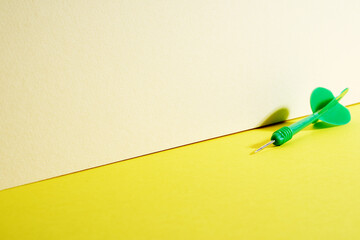 green color dart on yellow background