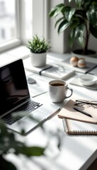 Minimalist workspace with laptop, coffee cup, and sunlight on desk