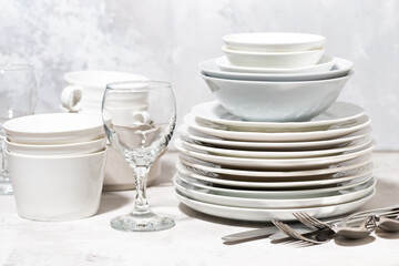 tableware, cutlery and glasses on a white background, closeup