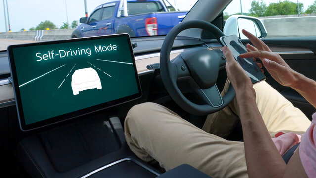 Self driving car or autonomous vehicle travel on speed highway with driverless system and autopilot mode allowing man driver relax and focus on smartphone without compromising safety. Perpetual
