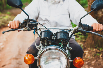 The motorcyclist is controlling the car while driving.