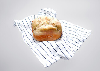 fresh bread lies on a white tablecloth