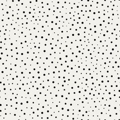 Vector dotted background. Irregular, imperfect dot pattern. Groups of big and small dots. Seamless hand drawn ornament made on tablet. Black and white illustration