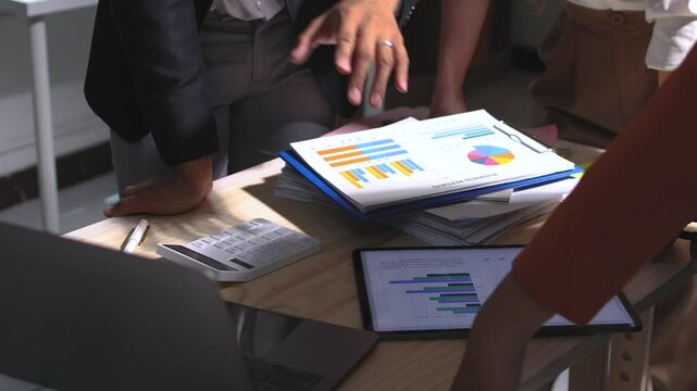 Young intern receiving feedback from her team leader and manager while presenting a project in office. Businesswoman working together analyzing financial data on laptop and business planning in office