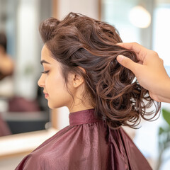 Fototapeta premium indian young woman getting her hair blow dried at a salon