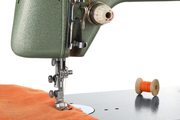 Sewing machine with orange fabric and spool of thread isolated on white