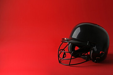 Black baseball helmet on red background, space for text