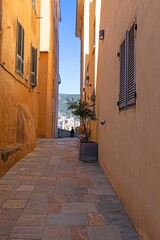 Quiet alley in an old Corsican mountain village with stone walls and rustic architecture