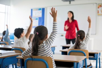 Students raise their hands to answer questions in a classroom.