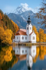Obraz premium Scenic Autumn Reflection of a Church by Mountains