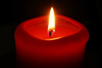 Red candle light sparkle and shine on dark background