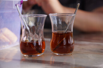 tea in traditional Turkish armudah glasses. two cups of tea with spoons