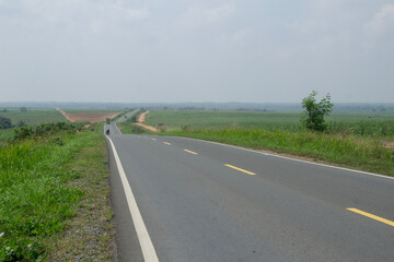 yellow striped asphalt road corner shot, empty asphalt road texture, lampung natural scenery cross-provincial road