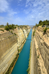 Corinth Canal, Greece. The Corinth Canal is a sluiceless shipping canal in Greece, connecting the Saronic Gulf of the Aegean and the Gulf of Corinth of the Ionian Sea