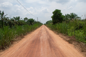 The unpaved rural roads are still dry red soil surrounded by trees