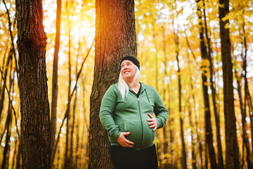 Nice Leabian pregnant woman in autumn park