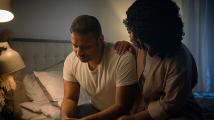 African American sad man sit on bed night evening at home suffer worried breakdown regret erectile dysfunction loving woman wife hug comforting support empathy crisis impotence potency health problem