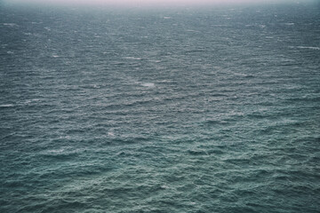 Rain over the stormy sea, abstract dark background landscape