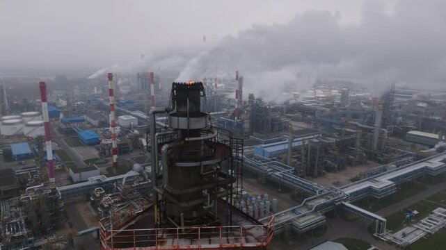  Industrial Refinery Emitting Smoke into Foggy Atmosphere