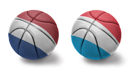 basketball balls with the national flags of luxembourg and netherlands on the white background.