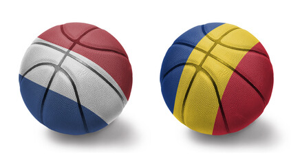 basketball balls with the national flags of romania and netherlands on the white background.