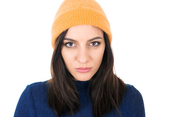 Serious young woman standing with neutral face expression, isolated on white background. Cute girl