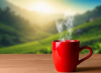 Obraz premium Tea cup on wooden table and plantations background