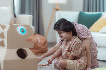A special child and his mom having fun and relaxing on a holiday together in the living room of the house