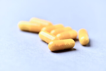 Vitamin C capsules. Bright background. Close up. Copy space.