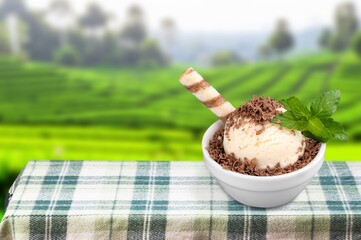 Morning cup of tasty ice cream with mountain background