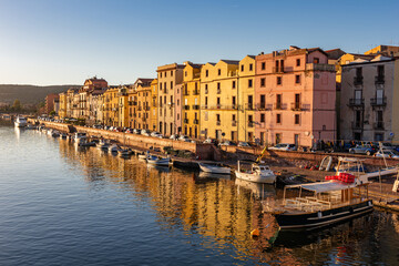 Fototapeta premium Panoramic view of the picturesque town of Bosa with its colorful houses reflected in the Temo River at golden hour. Sardinia, Italy.
