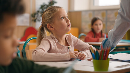 Caucasian woman teacher in elementary school teach children class kids writing task in classroom knowledge studying primary education lesson female tutor teaching learning boys girl study pupils learn