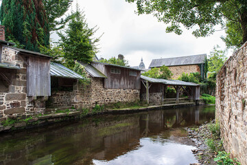 Fototapeta premium Old wash houses along the river Sienne in the town of Villedieu-Les-Poêles, Normandy, France