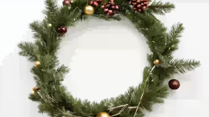 A beautifully crafted Christmas wreath made fresh pine tree branches cones olated white background video perfect use winter holiday invitation New Year’s greeting card banner plenty space text - Powered by Adobe