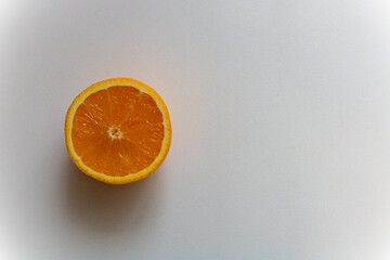 half of an orange on a white background