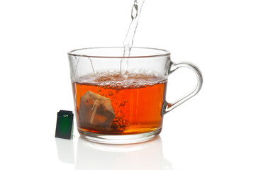 Glass cup with tea bag close up on a white background