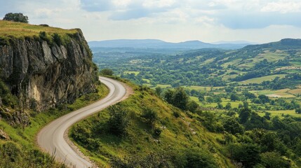 Fototapeta premium A winding road leading up to the top of a high cliff, with sweeping views of the countryside.