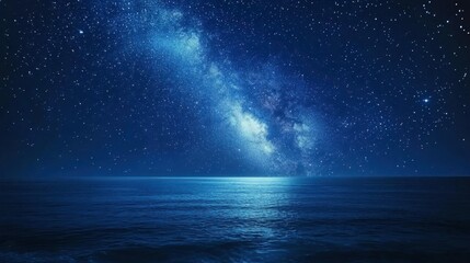 Fototapeta premium Blue sky turning into night, with stars dotting the sky and the galaxy's milky trail stretching above the sea.