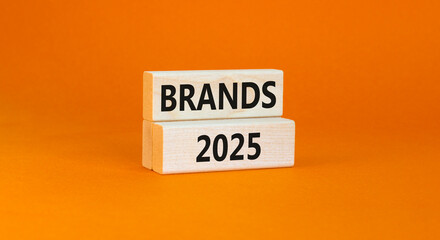 Planning brands 2025 new year symbol. Concept words Brands 2025 on beautiful wooden blocks. Beautiful orange background. Business brands 2025 new year concept. Copy space.