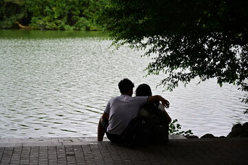 A young couple in love sitting at a lake in Hanoi-Vietnam.