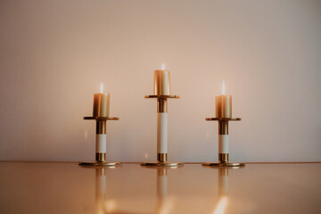 three candles on a light background