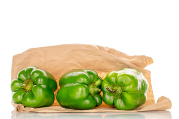 Sweet green capsicum on paper bag, macro, isolated on white background.