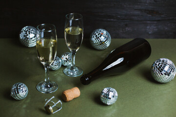 Glasses with champagne and Christmas balls on a beautiful background