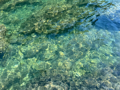 Beautiful clear water surface with underwater stones and pebbles