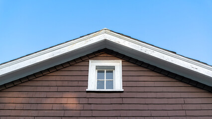 Old house gable end with fixed window in Brighton, Massachusetts, USA