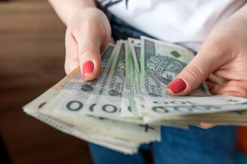  woman counts the polish zloty pln money, saving or rich concept