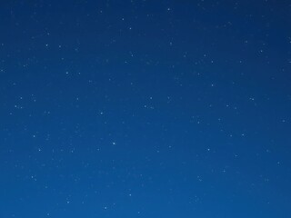 A spectacular meteor shower explodes across the vastness of a clear blue sky with shimmering lights, cosmic, celestial